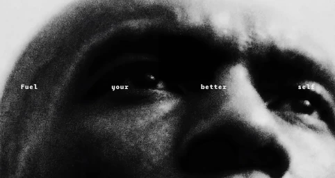 High-contrast, grainy black and white extreme close-up of a person's eyes with the text Fuel your better self across the frame.