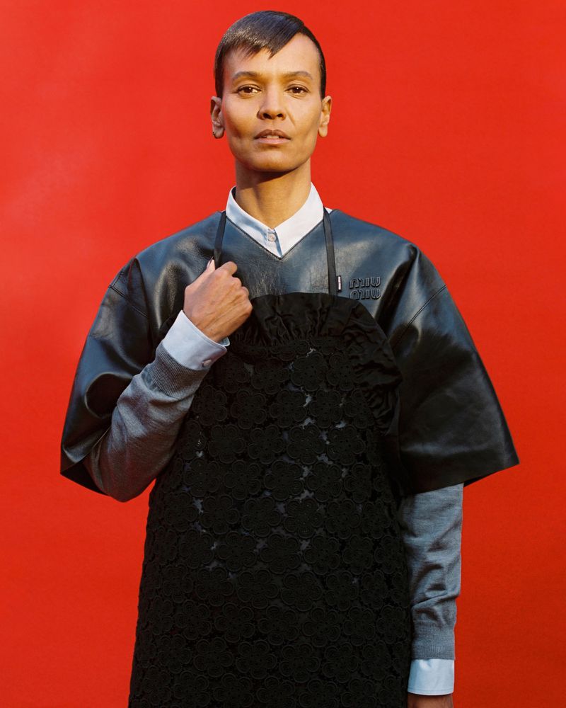 Model Liya Kebede wearing layered black leather and knitwear against a bright red studio backdrop for Re-Edition Magazine.