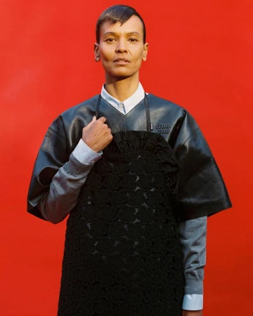Model Liya Kebede wearing layered black leather and knitwear against a bright red studio backdrop for Re-Edition Magazine.