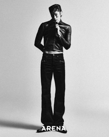Woohyeong Jang posing in a cropped black leather jacket and flared black trousers against a studio backdrop for Arena Homme+ Korea.
