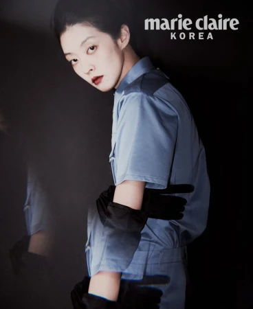 Model So Young Kang in a light blue short-sleeved collared shirt and black opera gloves against a dark background.