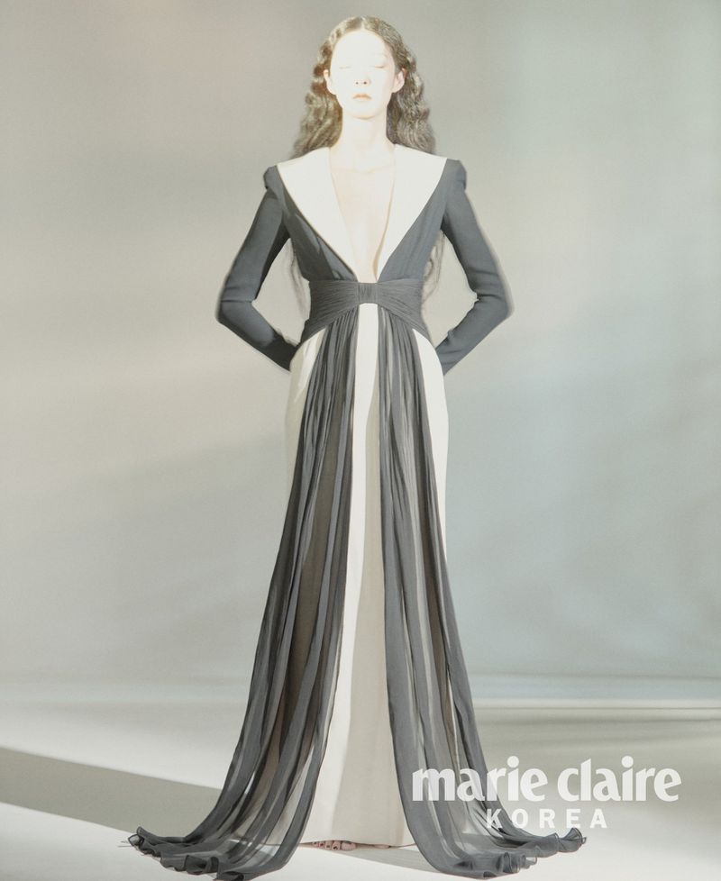 Model So Young Kang wearing a dramatic black and white plunge gown with long sheer draped panels for Marie Claire Korea.
