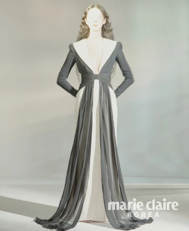 Model So Young Kang wearing a dramatic black and white plunge gown with long sheer draped panels for Marie Claire Korea.