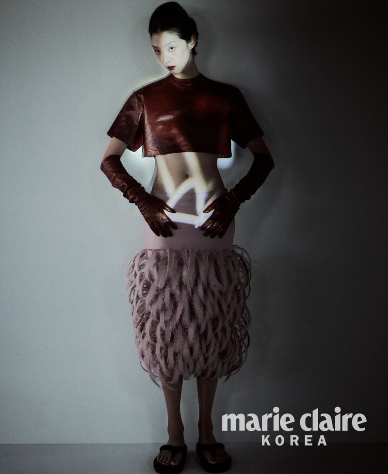 Model So Young Kang wearing a leather crop top, opera gloves, and textured looped skirt for Marie Claire Korea.