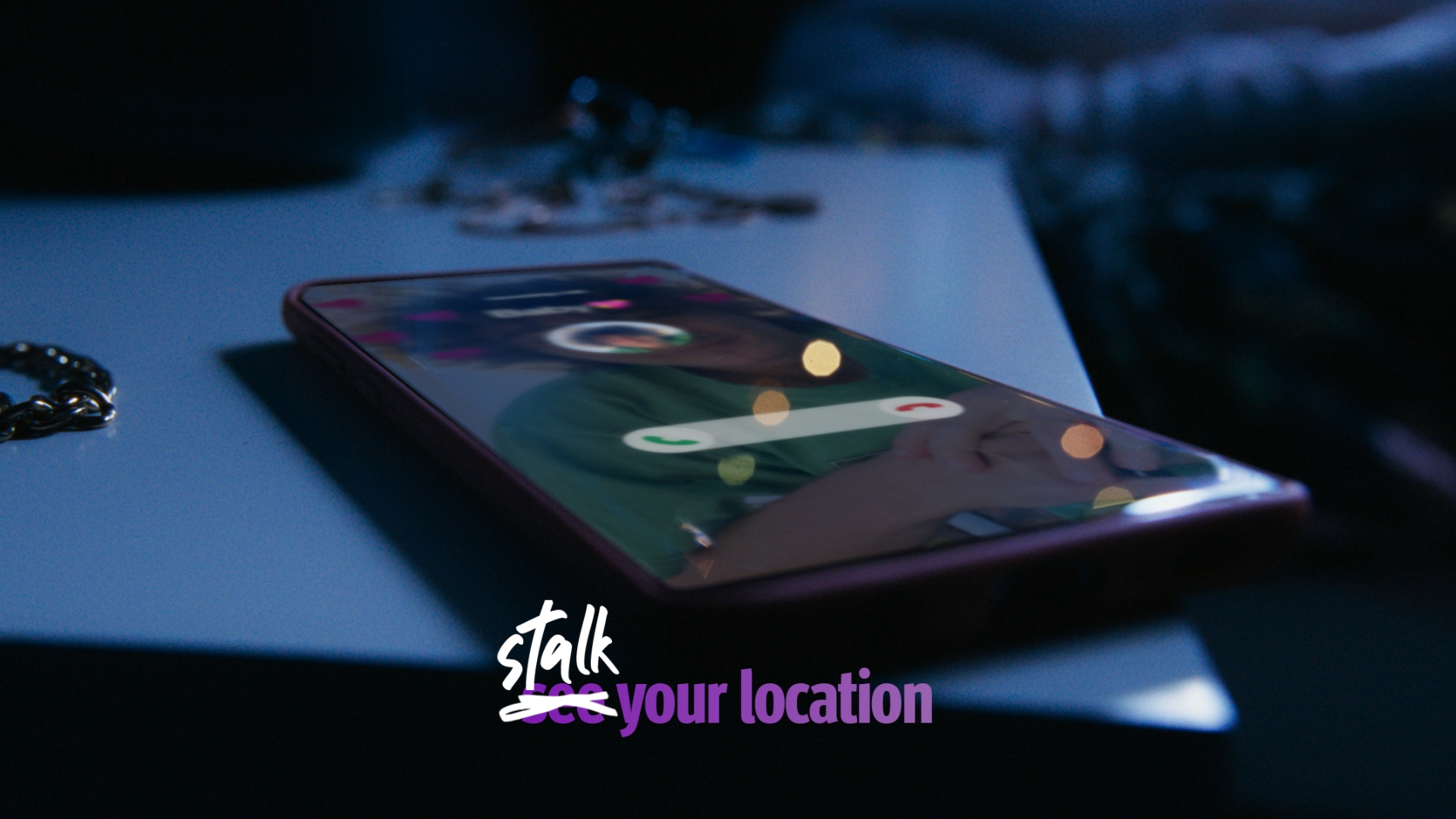Illuminated smartphone resting on a nightstand with a blurred background, displaying a call screen with incoming call interface.