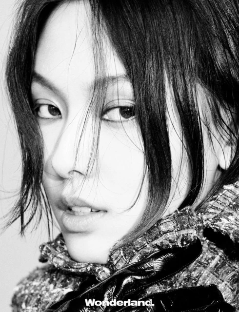 Behind the screen, she rises