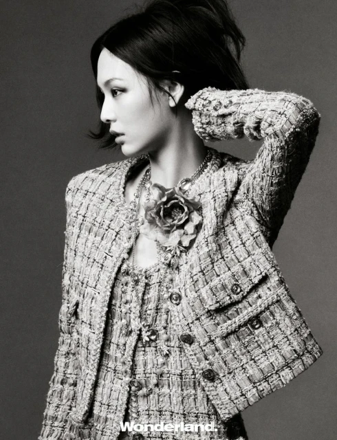 Behind the screen, she rises