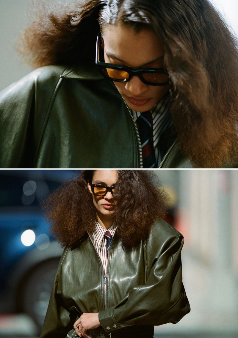 Model with voluminous hair wearing a green leather jacket and sunglasses for Cero Magazine editorial.