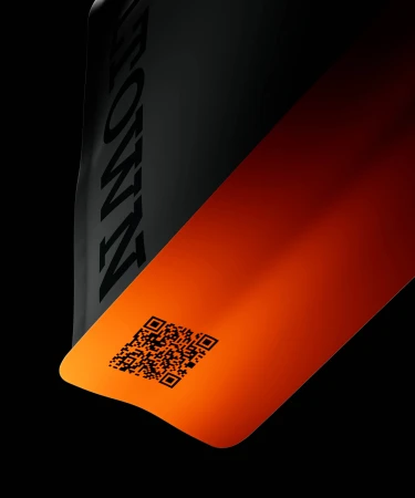 Close-up of black and orange Coaltown Coffee packaging featuring a printed QR code against a dark background.