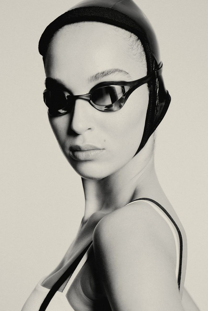 Model Yente Reitsma wearing a black swim cap, dark goggles, and swimwear against a studio backdrop for Max Zara Sterck.