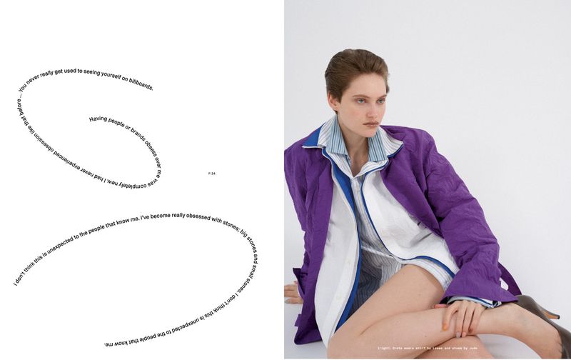 Magazine editorial spread featuring model Greta Hofer in a purple jacket and white shirt next to a page with curved typography.