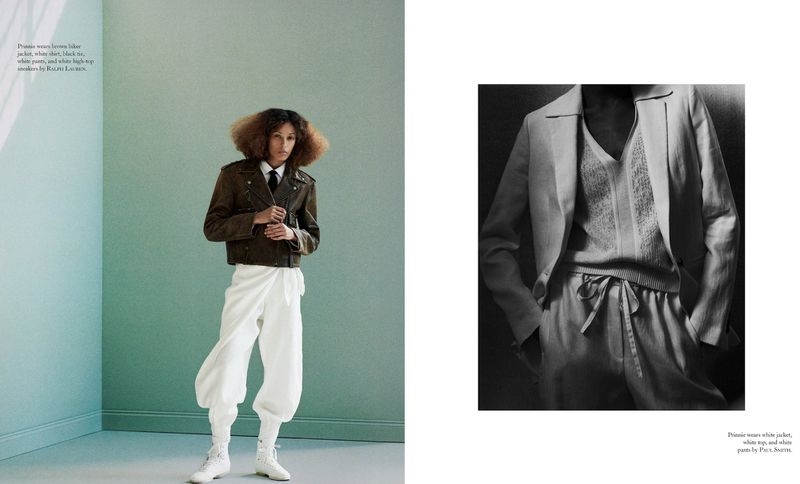 Fashion editorial featuring a woman in a brown leather jacket, white shirt, tie, and voluminous white pants posing in a minimalist studio.