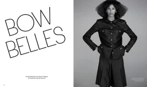 Model Prinnie Stott wearing a black buttoned jacket and skirt against a grey background for Mission Magazine