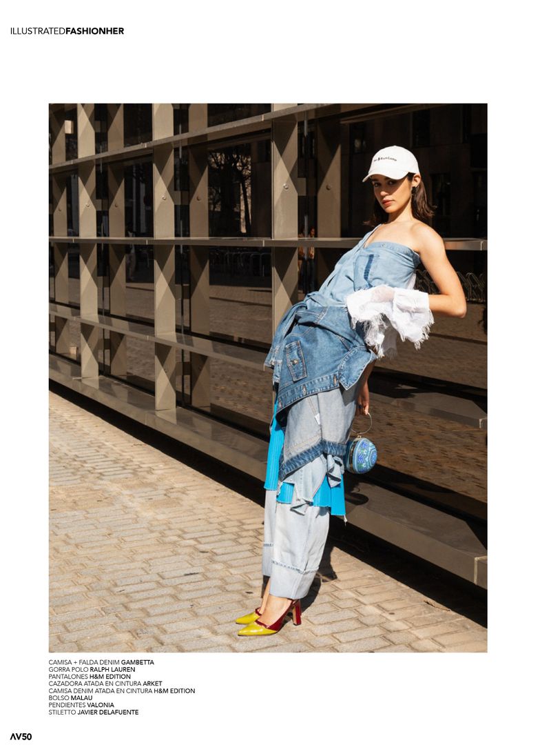 Model wearing layered denim pieces and a white baseball cap, leaning against a modern architectural facade in direct sunlight.
