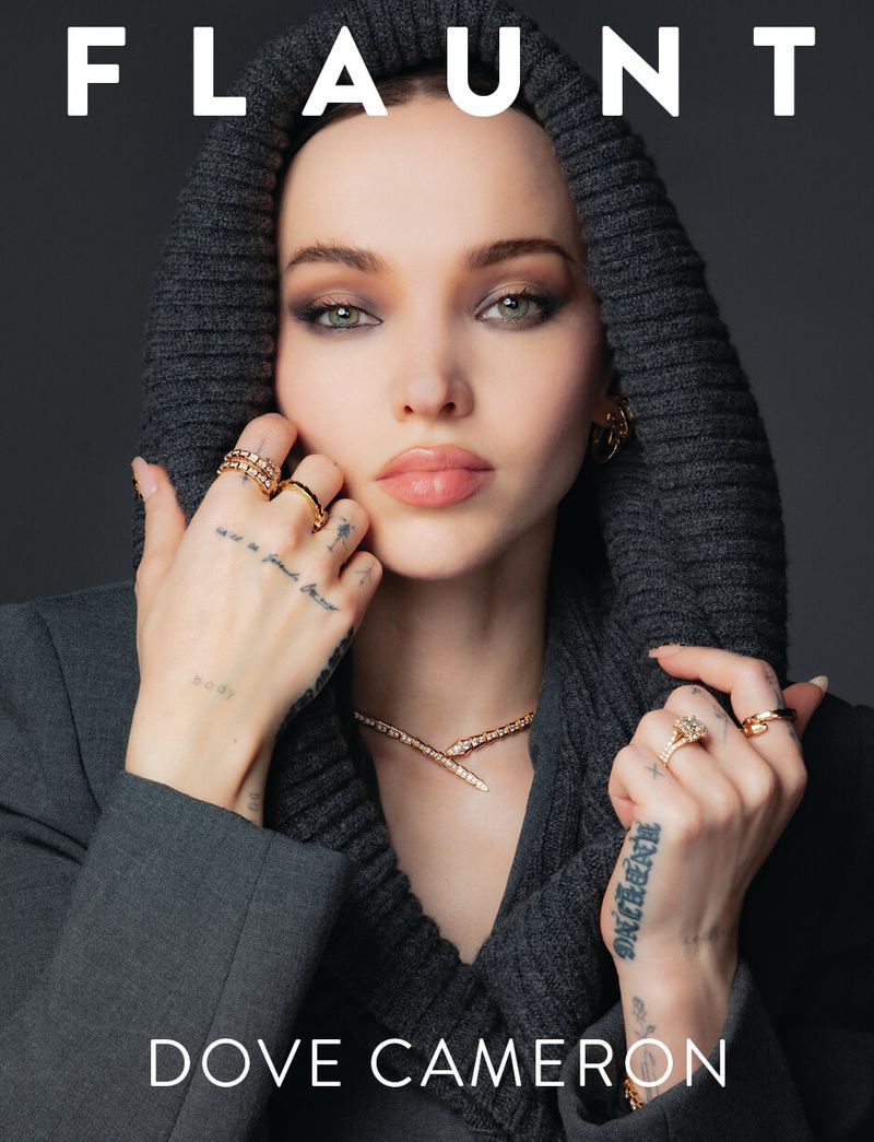 Dove Cameron wearing a dark grey ribbed knit hood and gold jewelry on the cover of Flaunt Magazine.