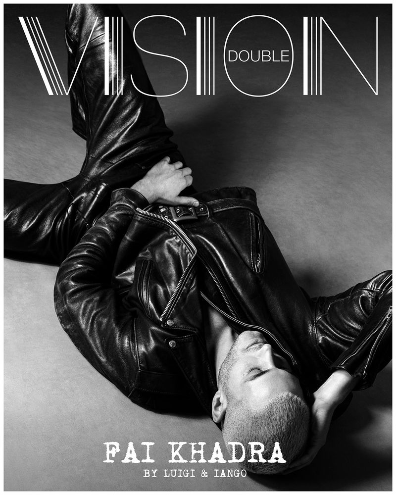 Fai Khadra reclining in a black leather jacket and leather pants on a neutral backdrop for Double Vision magazine.