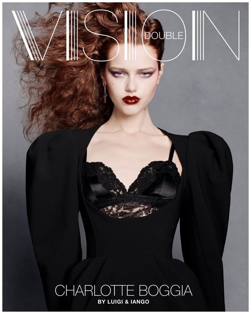 Charlotte Boggia wearing a black dress with puff sleeves and lace bustier on the cover of Double Vision magazine.