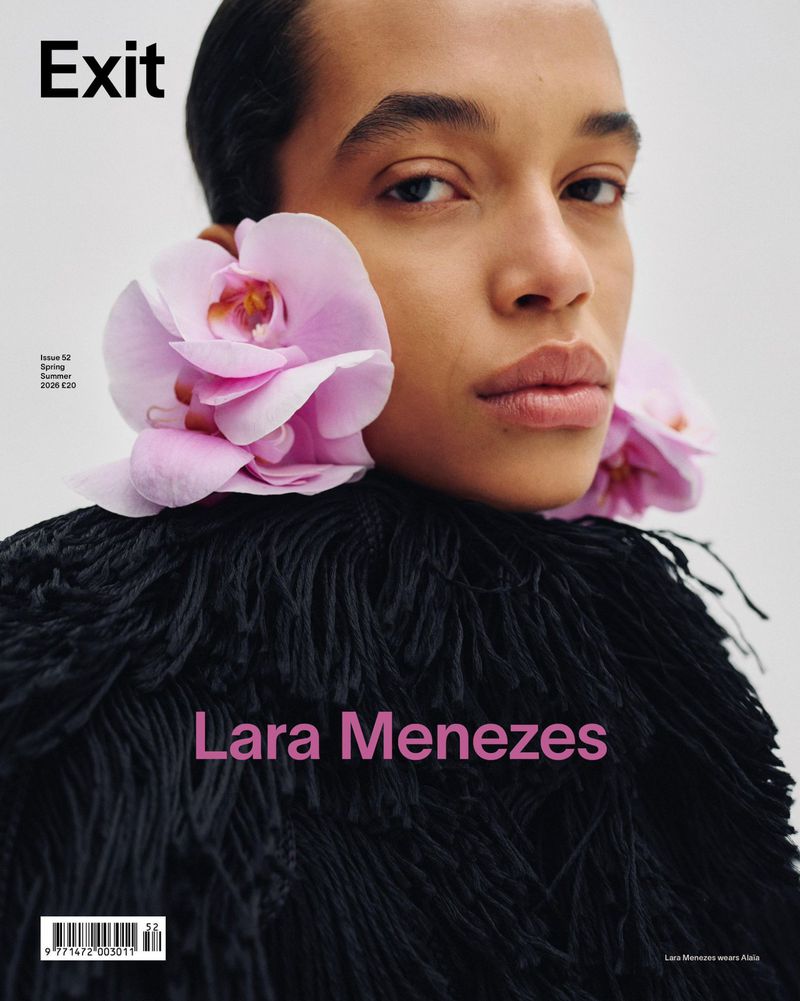 Model Lara Menezes wearing oversized pink orchid earrings and a black textured fringe collar on a magazine cover.