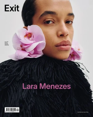 Model Lara Menezes wearing oversized pink orchid earrings and a black textured fringe collar on a magazine cover.