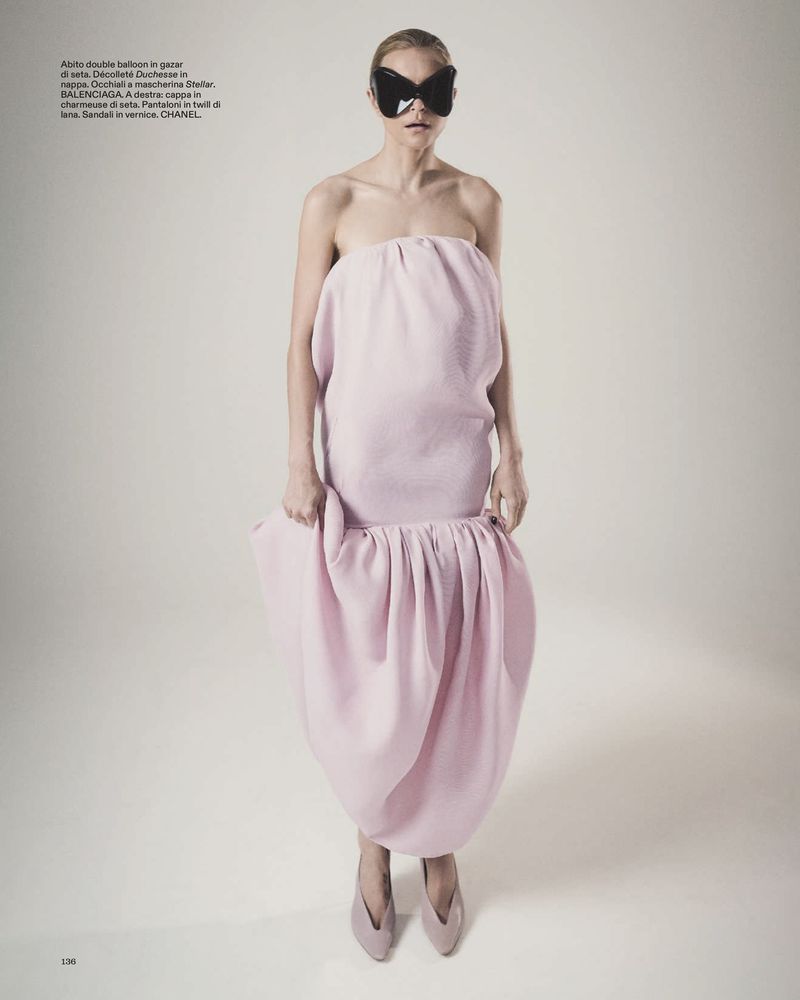 Jessica Stam in a strapless pink balloon dress and black butterfly sunglasses against a pale studio backdrop.