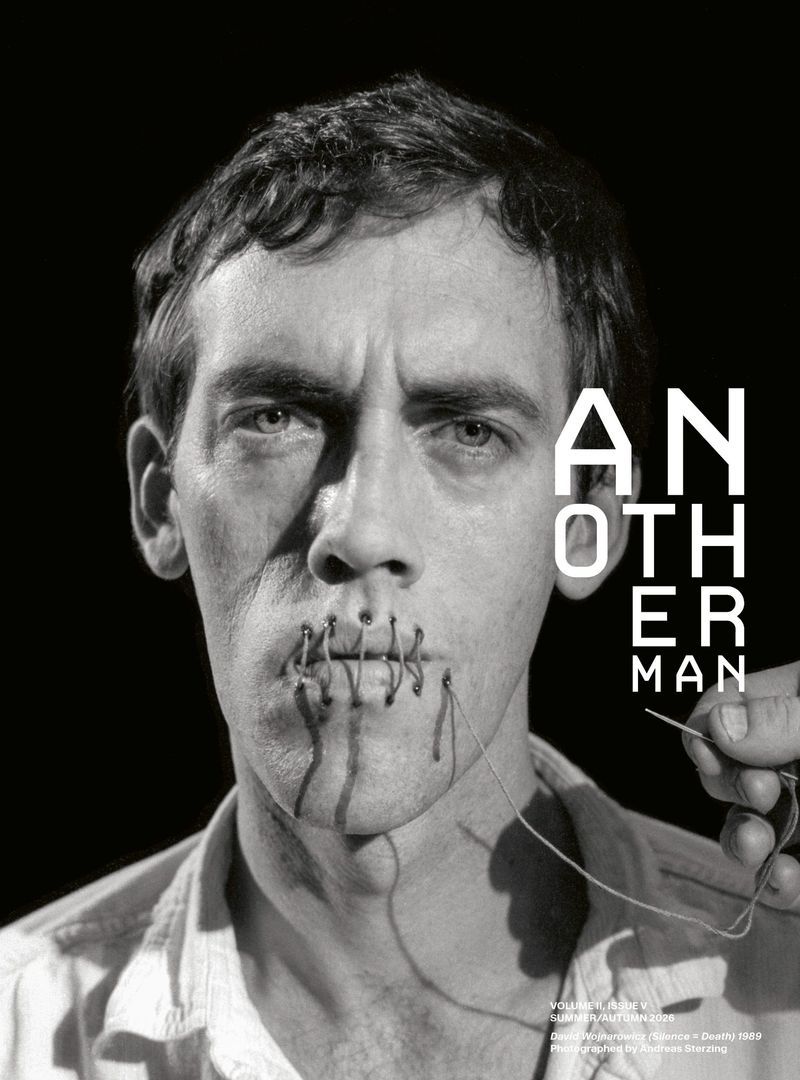 Portrait of a man with lips stitched shut by a needle and thread against a black background for AnOther Man Magazine.
