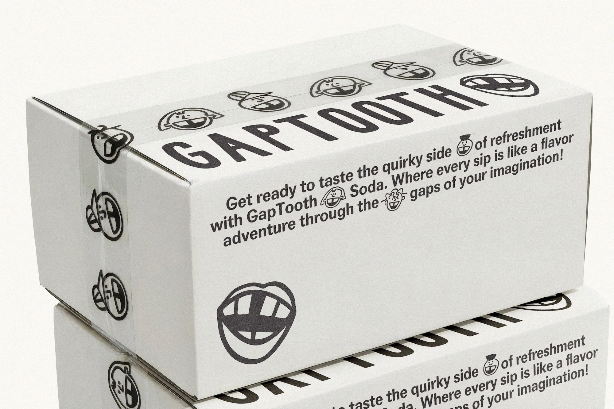 White cardboard box branded with GAPTOOTH text, graphic mouth illustrations, and promotional text on a white seamless background