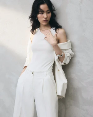 Model Song Ah Woo wearing a white tank top and tailored trousers with a jacket for H&M