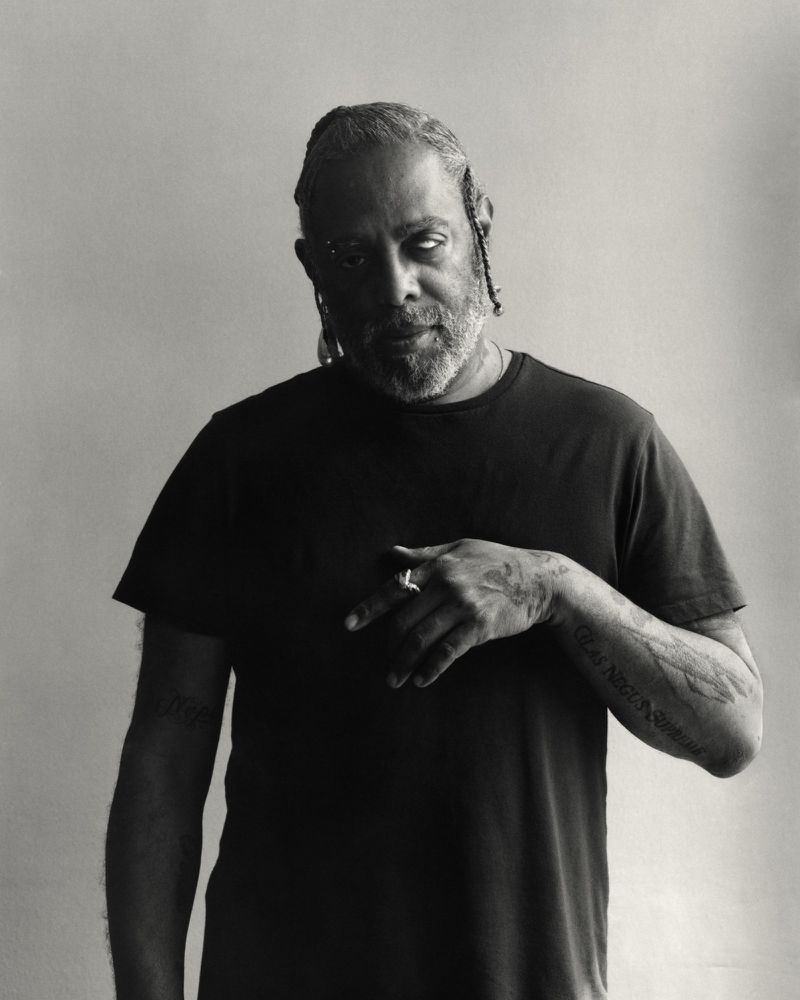 Monochrome portrait of artist Arthur Jafa wearing a black t-shirt against a plain background