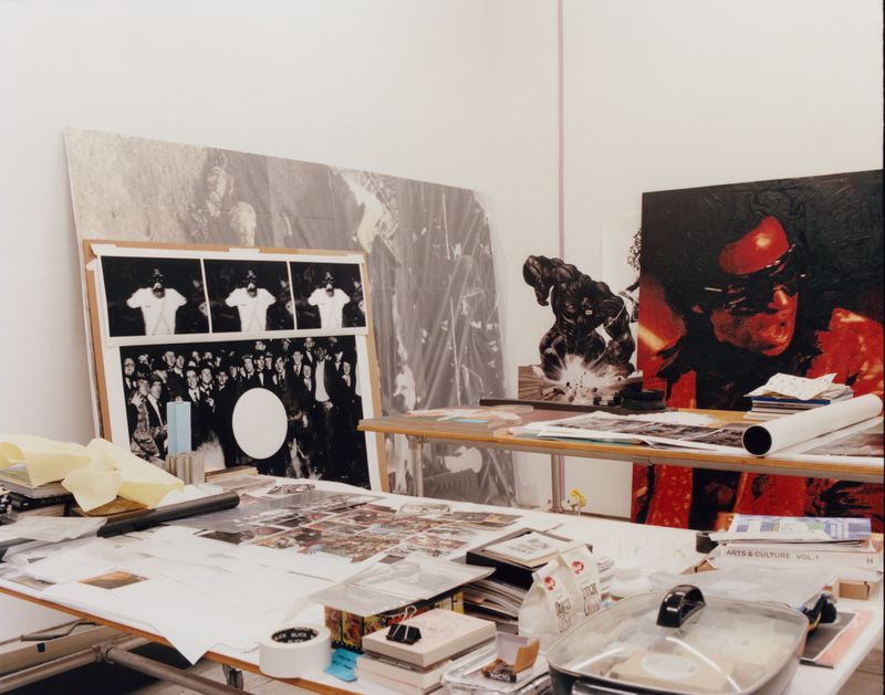 An artist's studio filled with various artworks, paintings, and creative supplies, showcasing the environment of artistic creation.