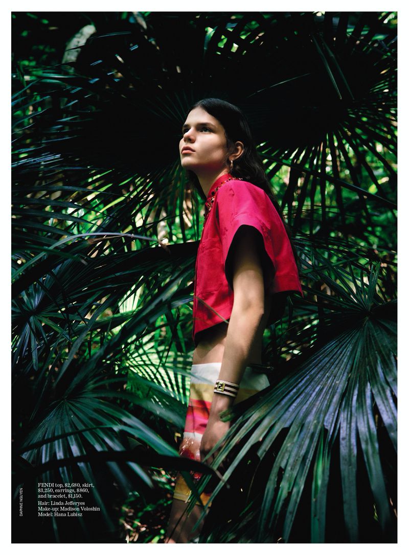 Model Hana Lubisz in a pink top posing amidst lush green palm fronds for the Vogue Australia Super Nature editorial project.