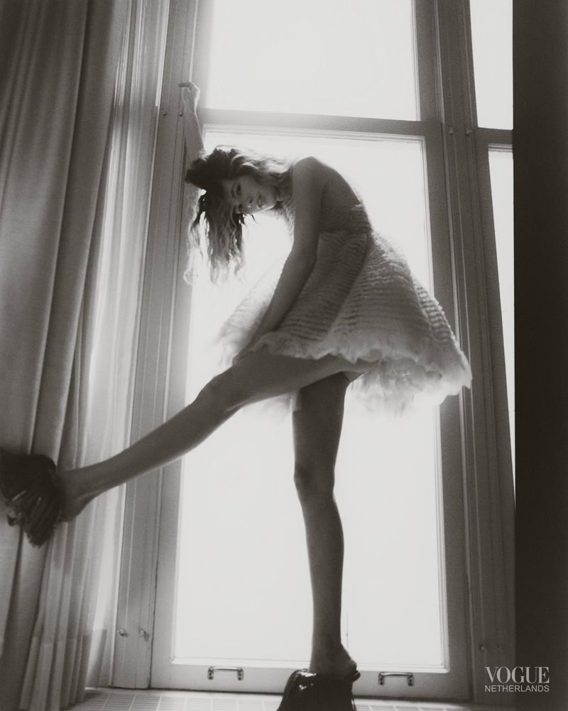 Model in a textured white dress standing on a windowsill against a bright window for Vogue Netherlands TILL STYLE DO US PART editorial.
