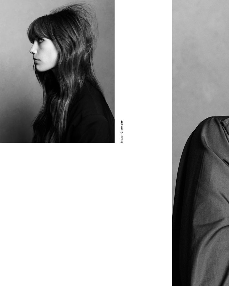 Monochrome studio portrait of a woman in profile wearing a dark blazer against a grey backdrop for Double Vision Betsy.