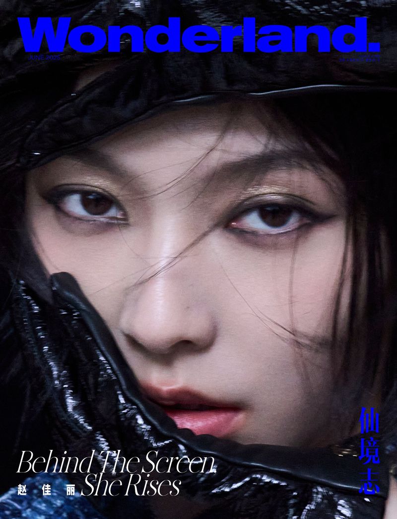 Close-up portrait of model Jiali Zhao with dark winged eyeliner wearing a glossy black hat for Wonderland China.