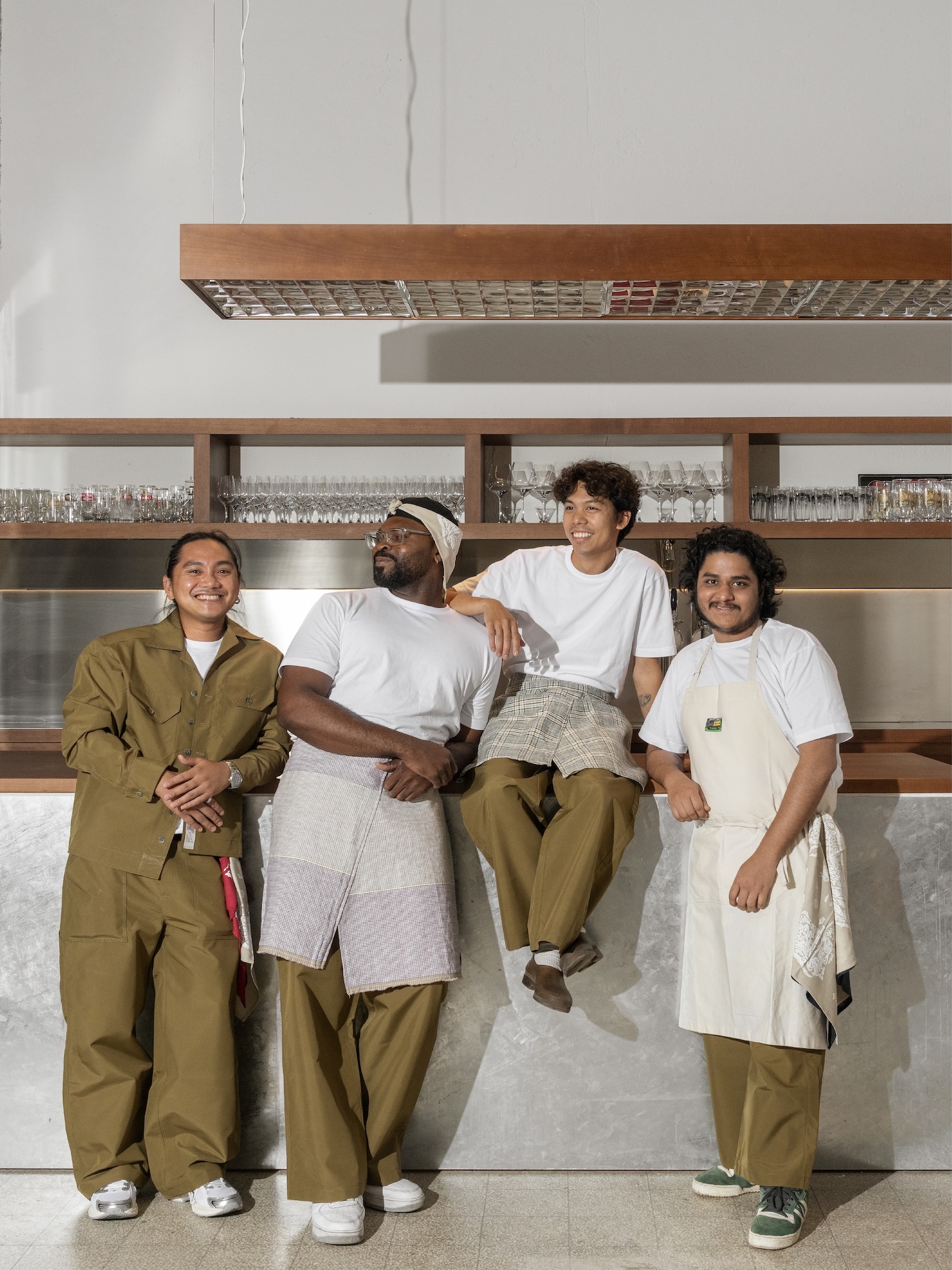 Four staff members posing behind a modern bar counter for Balay brand identity