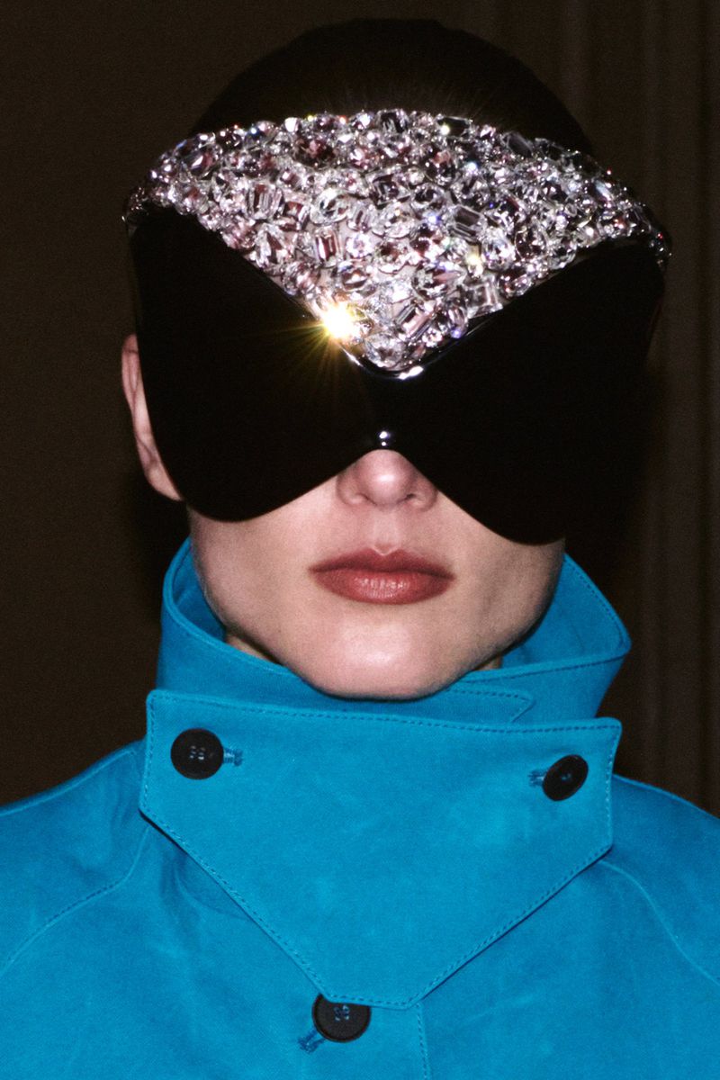 Model Gertrud Rose wearing a jewelled visor and bright blue coat for Re-Edition Magazine