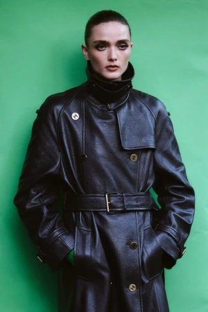Model Gertrud Rose in a black leather belted coat against a green backdrop for Re-Edition Magazine by Phil Engelhardt