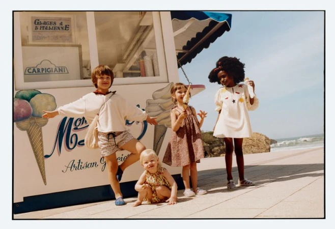 Children posing in front of an ice cream kiosk near the beach for Zara Summer Memories campaign photographed by Toby Coulson.