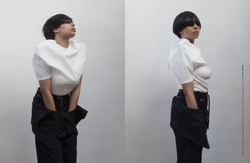 Model in white t-shirt and black trousers posing against a white background for Dry Clean Only Magazine