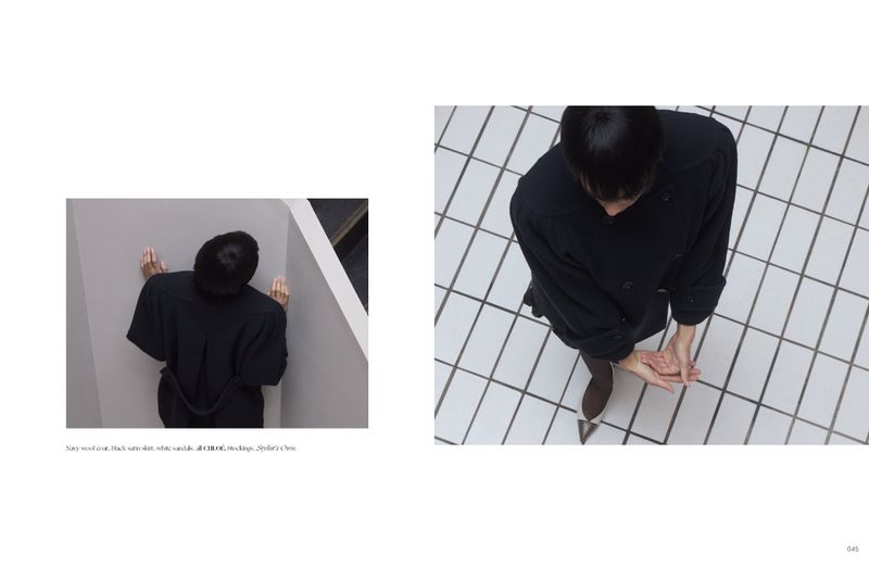 High-angle editorial spread featuring a person in a dark coat and two-tone heels against a white tiled floor and grey corner wall.