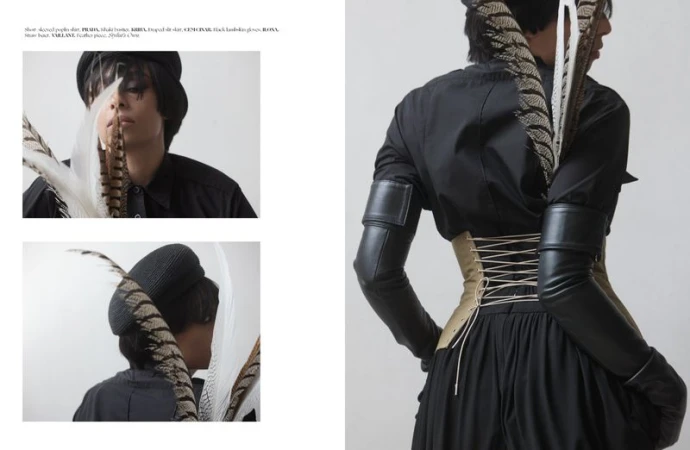 Editorial layout featuring a model wearing a black shirt, khaki corset, and feathers against a white background.