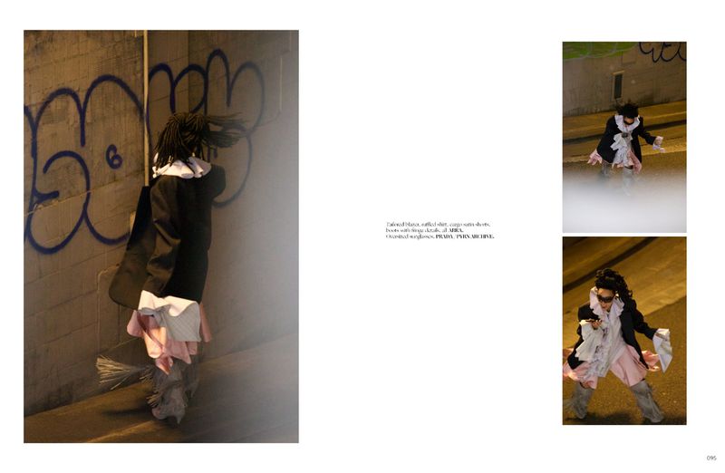 Spread showing a fashion editorial layout with models in dark coats and ruffled collars against a graffiti wall