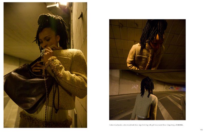 Model with locs wearing a tweed jacket holding a dark leather bag in an underpass for Dry Clean Only Magazine