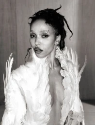 Portrait of FKA twigs wearing a white feathered garment in a 10 Magazine editorial photographed by Ib Kamara