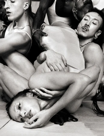 Black and white editorial portrait of a group of people intertwined in a dynamic sculptural pose for 10 Magazine