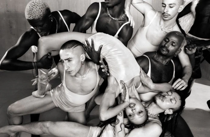 FKA twigs arched horizontally over a group of dancers in matching light tank tops and shorts in 10 Magazine