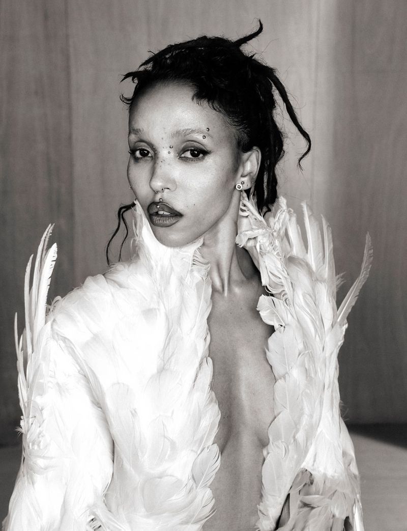 Portrait of FKA twigs wearing a white feathered garment in a 10 Magazine editorial photographed by Ib Kamara