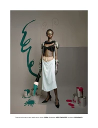 Model Alay Deng holding a giant paintbrush in a studio set with paint cans, for Numéro New York Character Studies