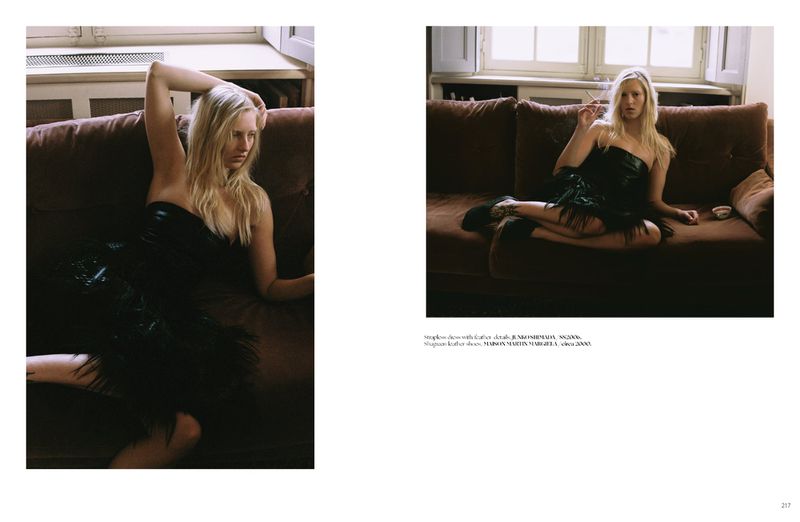 Model Vilma Friedlander lounging on a brown sofa in a black strapless dress for Dry Clean Only Magazine