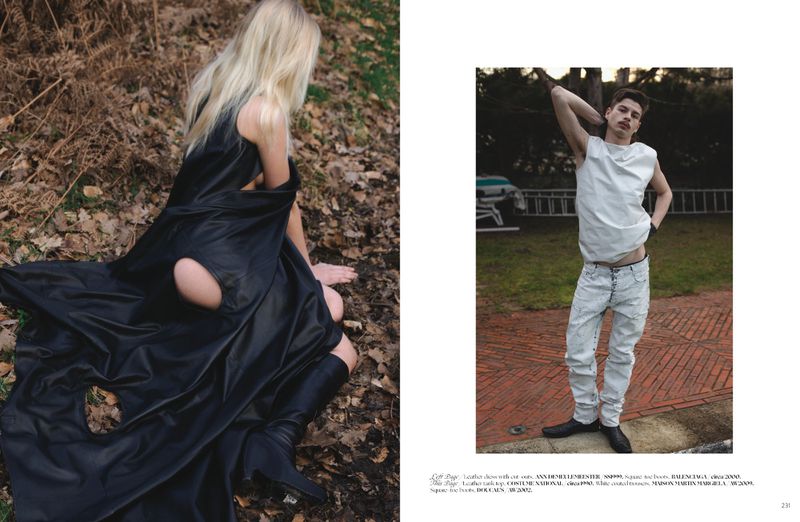 Model with long blonde hair wearing a black dress with cut-outs and black boots outdoors in a wooded setting