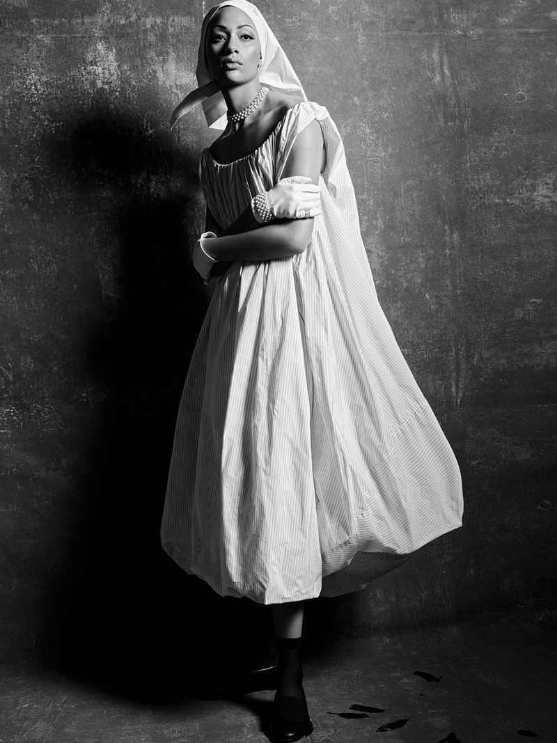 Model Selena Forrest wearing white dress, headscarf and gloves against textured wall in Selena's Dream project for D Repubblica